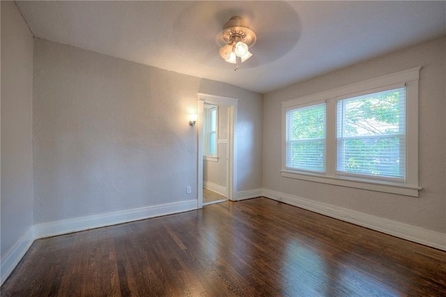 unfurnished room with dark wood-type flooring and ceiling fan