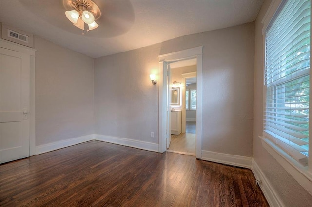 unfurnished room with ceiling fan, dark hardwood / wood-style flooring, and a wealth of natural light