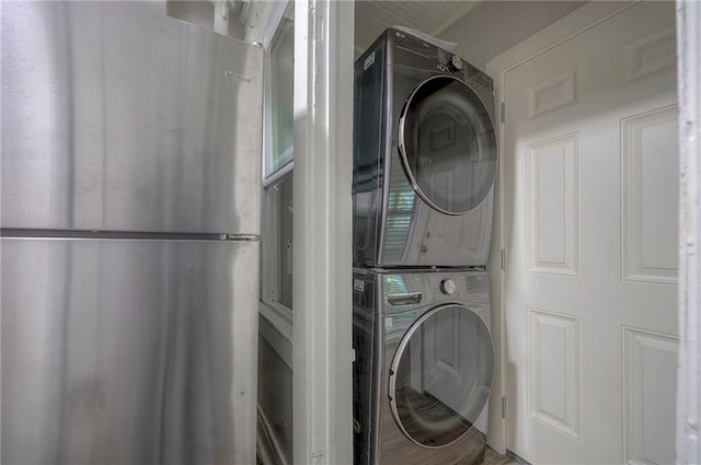 laundry room featuring stacked washer / drying machine