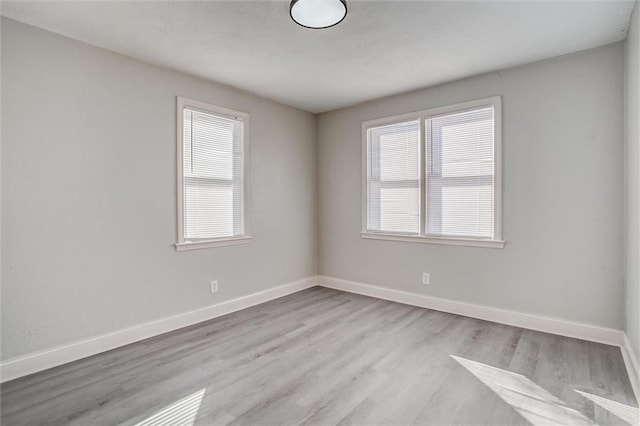 spare room featuring light wood-type flooring