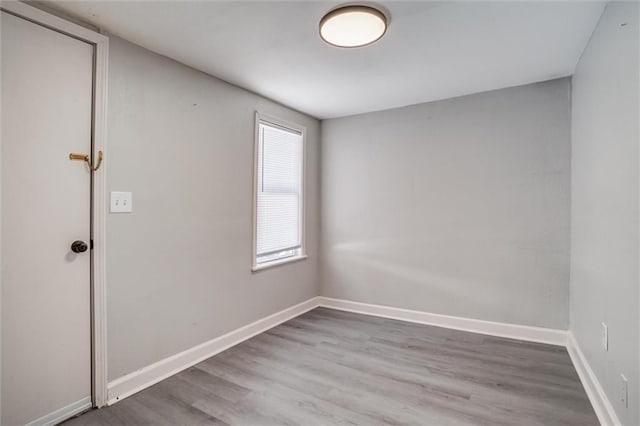 unfurnished room with wood-type flooring