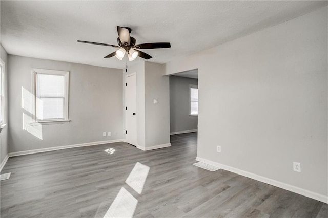 spare room with wood-type flooring and ceiling fan