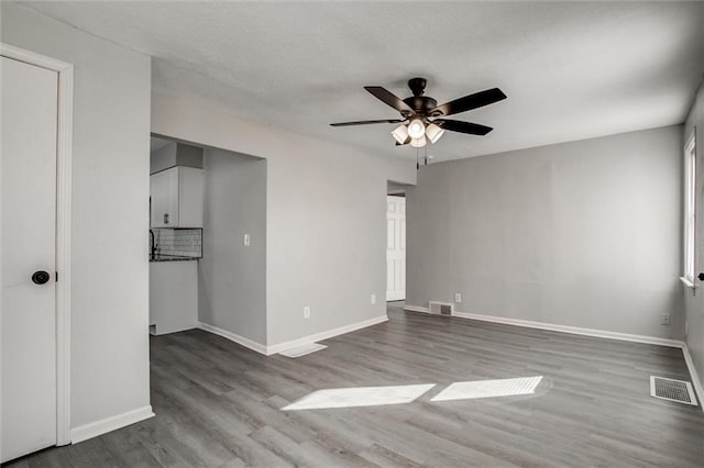 unfurnished bedroom featuring hardwood / wood-style floors and ceiling fan