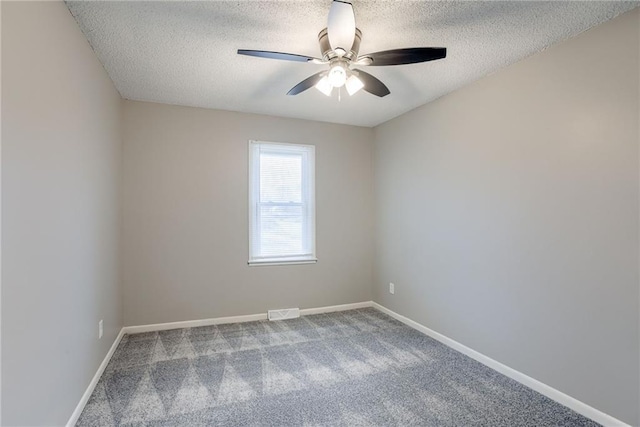 carpeted spare room with ceiling fan and a textured ceiling