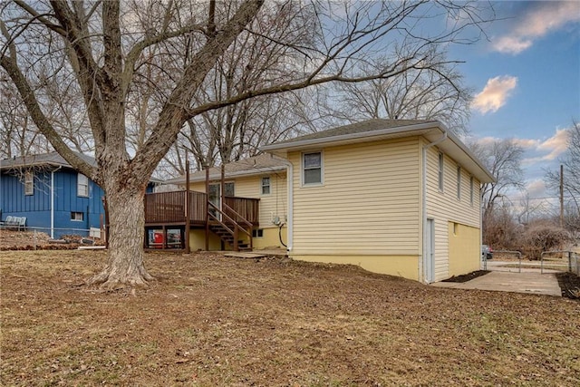 back of property featuring a wooden deck