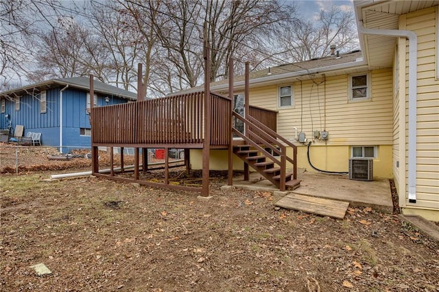 back of house featuring a wooden deck and central AC unit