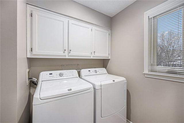 washroom featuring separate washer and dryer and cabinet space