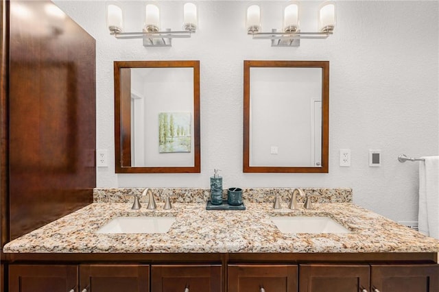 full bathroom featuring double vanity and a sink