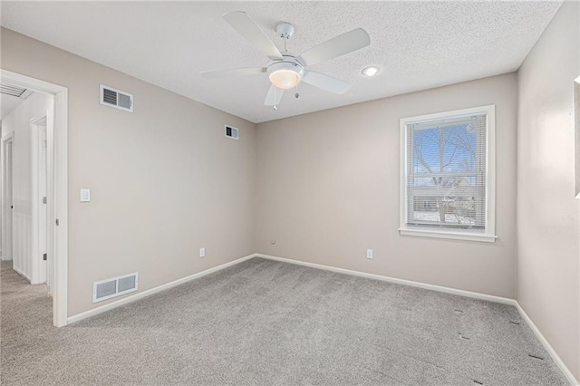 empty room with visible vents, light carpet, and baseboards