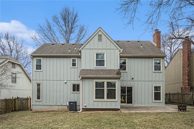 rear view of house with a shingled roof, a fenced backyard, a patio, and a chimney