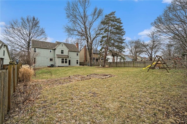 view of yard with a playground and a fenced backyard