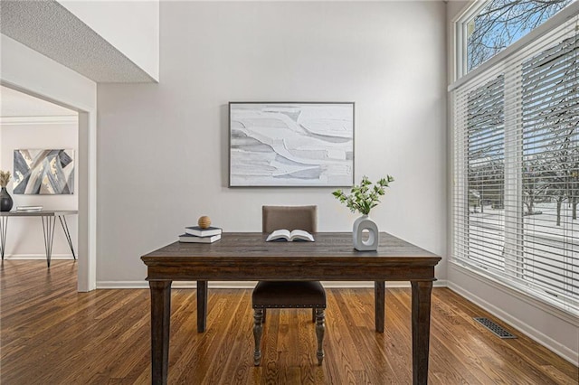 office with visible vents, baseboards, and wood finished floors