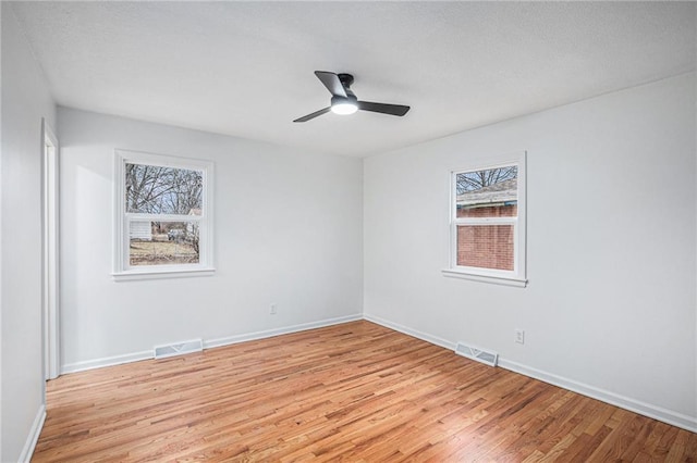 empty room with light hardwood / wood-style flooring and ceiling fan