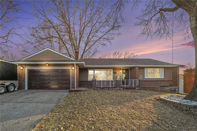 ranch-style house featuring a garage and covered porch