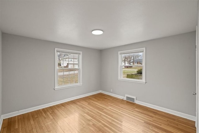 unfurnished room with light wood-type flooring