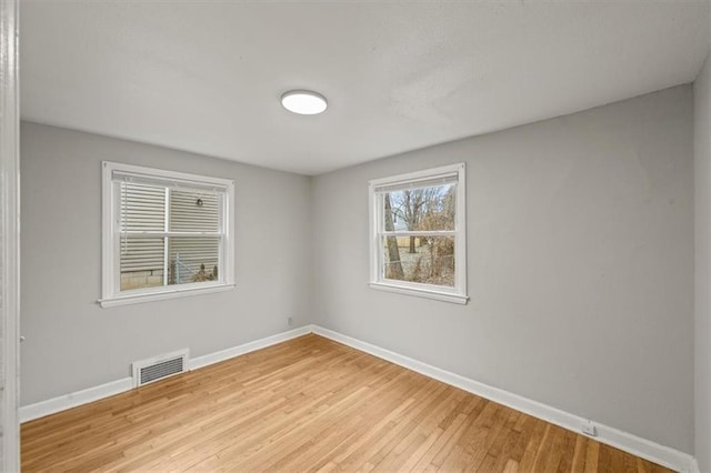 unfurnished room with light hardwood / wood-style flooring