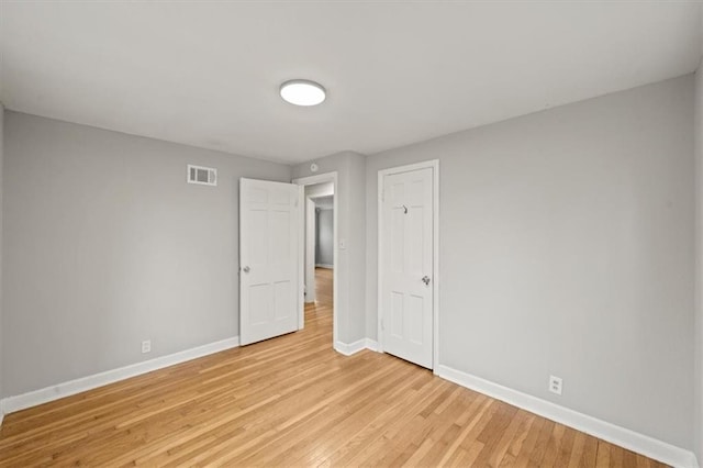 unfurnished room with light wood-type flooring