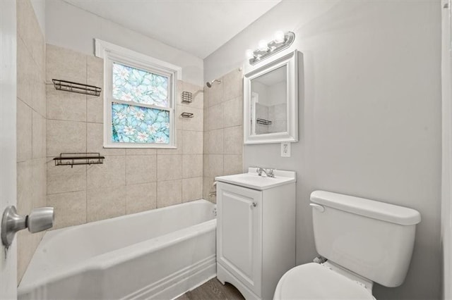 full bathroom with vanity, tiled shower / bath, and toilet