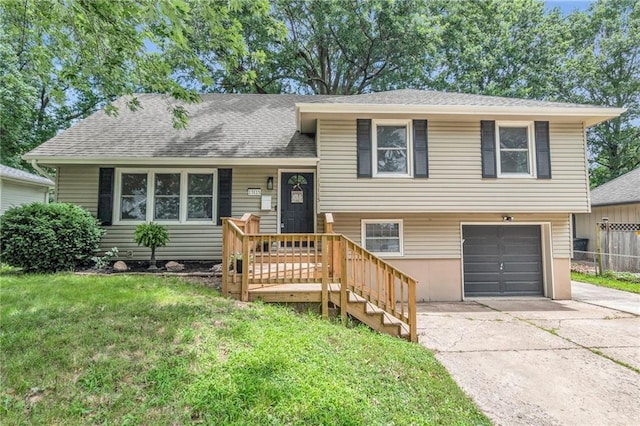 split level home with a garage and a front yard