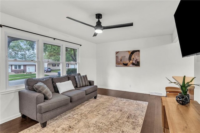 living room with hardwood / wood-style floors and ceiling fan