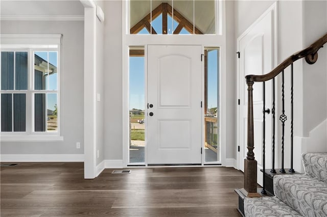 foyer with crown molding and dark hardwood / wood-style floors