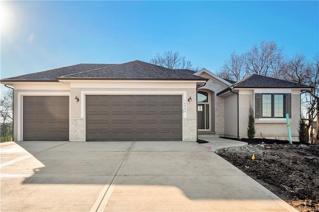 25297 W 149th Ter, Olathe, KS 66061 - view of front facade with a garage, concrete driveway, roof with shingles, stucco siding, and stone siding