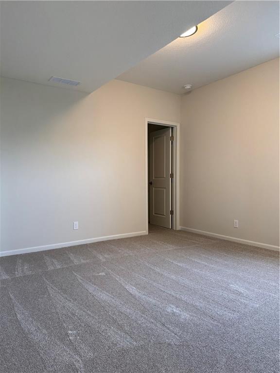 25297 W 149th Ter, Olathe, KS 66061 - unfurnished room featuring dark colored carpet and baseboards