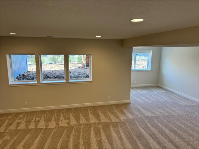 25297 W 149th Ter, Olathe, KS 66061 - spare room with light colored carpet, baseboards, recessed lighting, and a textured ceiling
