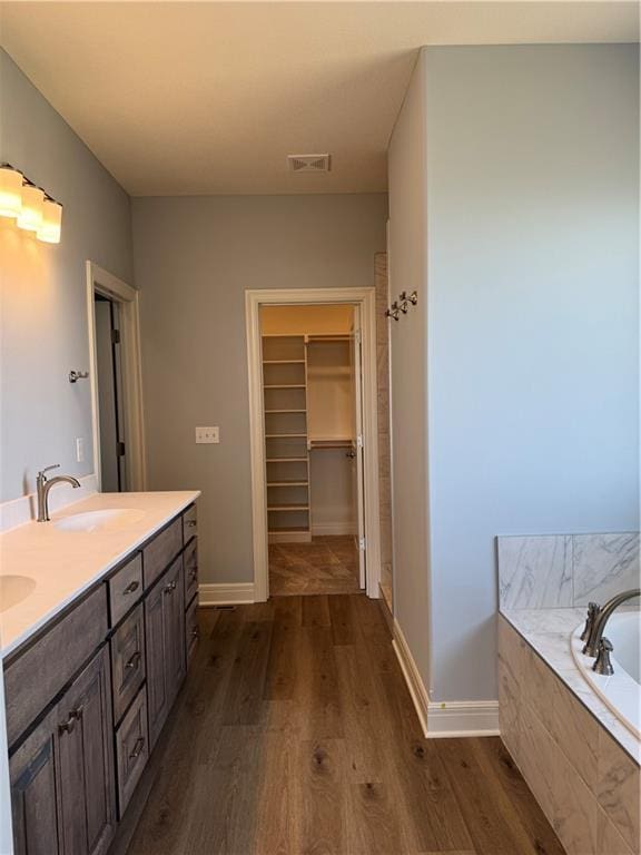 25297 W 149th Ter, Olathe, KS 66061 - full bath featuring wood finished floors, double vanity, a bath, and baseboards