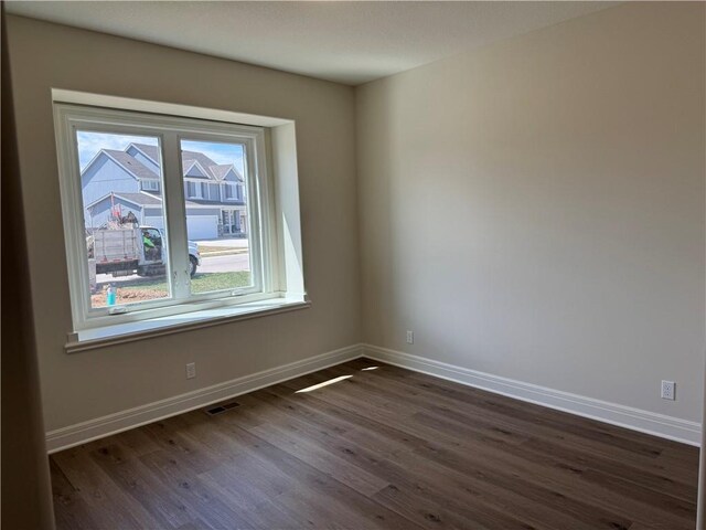 25297 W 149th Ter, Olathe, KS 66061 - unfurnished room featuring dark wood-style flooring and baseboards