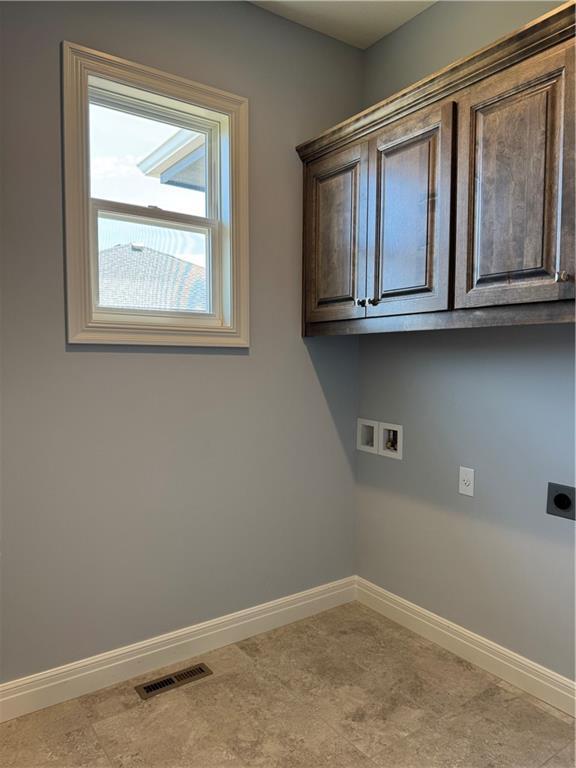 25297 W 149th Ter, Olathe, KS 66061 - laundry room featuring washer hookup, baseboards, electric dryer hookup, and cabinet space