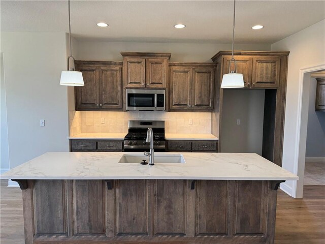 25297 W 149th Ter, Olathe, KS 66061 - kitchen featuring appliances with stainless steel finishes, a sink, baseboards, backsplash, and recessed lighting