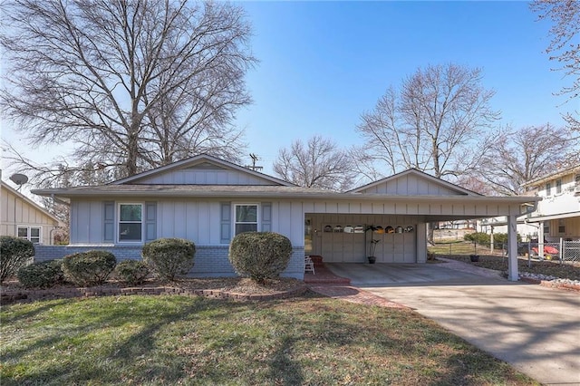 view of front facade featuring brick siding, concrete driveway, an attached garage, board and batten siding, and a front yard