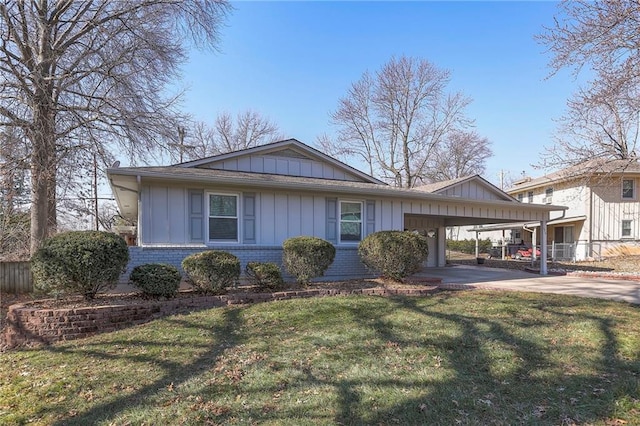 view of front facade featuring brick siding, board and batten siding, an attached carport, driveway, and a front lawn