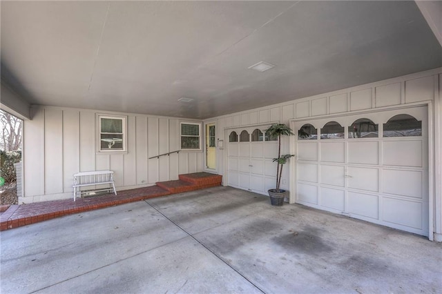 garage featuring concrete driveway