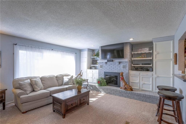 living area with carpet, a textured ceiling, a brick fireplace, and recessed lighting