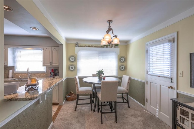 dining area featuring a chandelier and light colored carpet