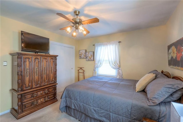 bedroom with light carpet and a ceiling fan