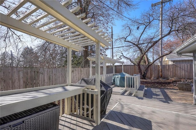 wooden terrace featuring a fenced backyard