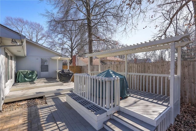 wooden deck featuring a fenced backyard and grilling area