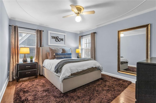 bedroom featuring ceiling fan, ornamental molding, wood finished floors, and baseboards