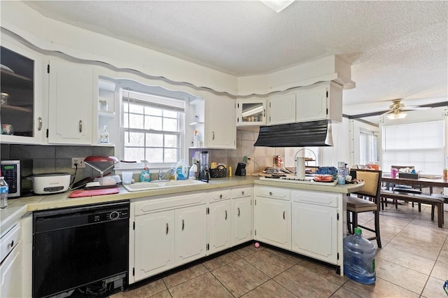 kitchen featuring a sink, black dishwasher, decorative backsplash, open shelves, and stainless steel microwave