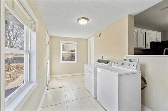 laundry room with laundry area, washer and clothes dryer, visible vents, and a healthy amount of sunlight