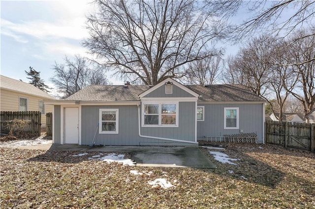 rear view of house featuring a patio area, a chimney, and fence