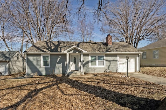 single story home featuring a garage, driveway, a shingled roof, and a chimney