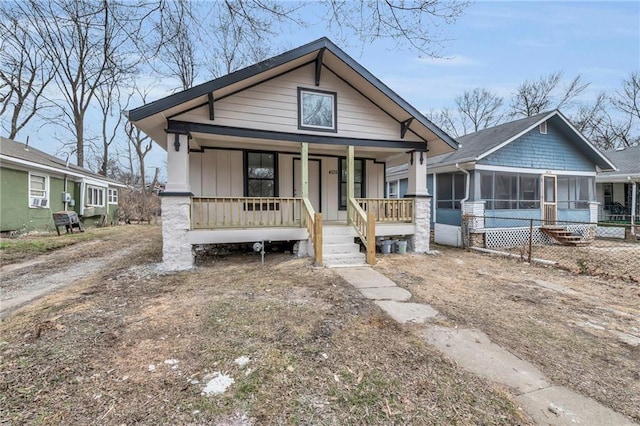 bungalow-style home featuring a sunroom and covered porch