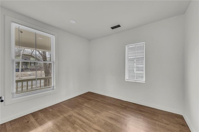 unfurnished room with hardwood / wood-style flooring