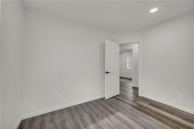 empty room featuring dark hardwood / wood-style flooring