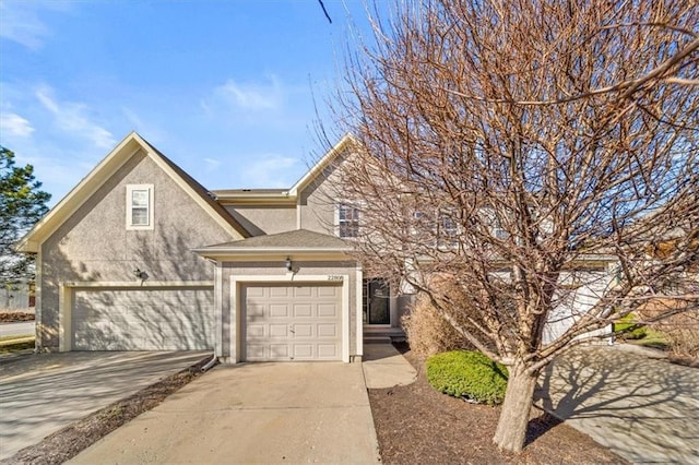 view of front of home with an attached garage, driveway, and stucco siding