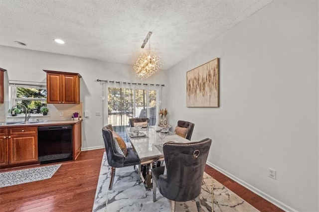 dining area featuring a chandelier, plenty of natural light, dark wood finished floors, and baseboards